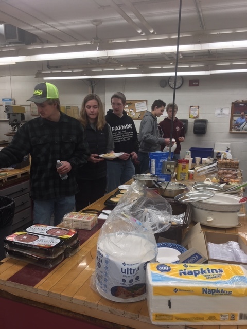 FFA STUDENTS MAKING PANCAKES, BACON, AND SAUSAGE FOR STAFF